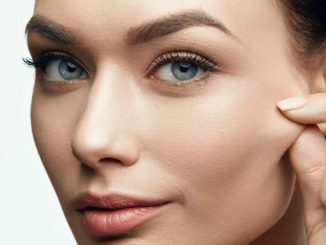 Woman pinching face checking for collagen