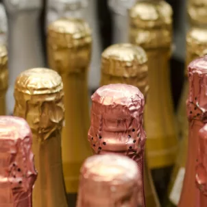 Bottles of champagne with silver, gold, and rose gold foil