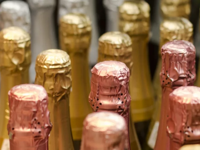 Bottles of champagne with silver, gold, and rose gold foil