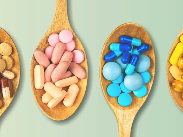 4 wooden spoons of different colored beautiful vitamins and nutrients for skin health