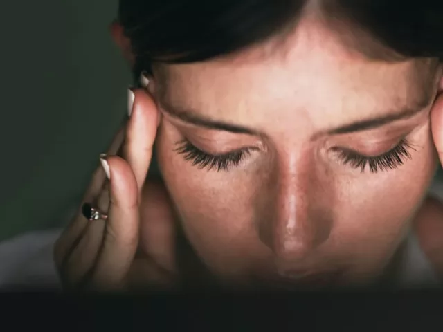 Stressed woman rubbing temples