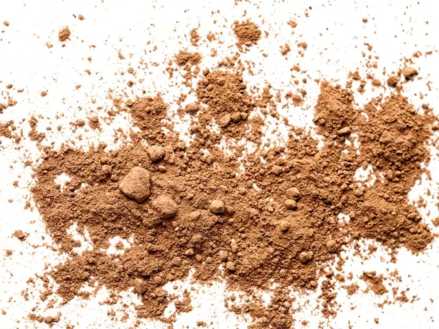 Brown powder splayed out on white background