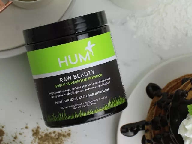 HUM Raw Beauty on kitchen counter next to a stack of chocolate-drizzled pancakes