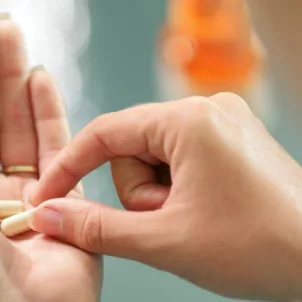 Woman holding the best probiotic capsule in her palm