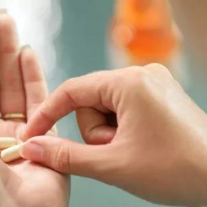 Woman holding the best probiotic capsule in her palm