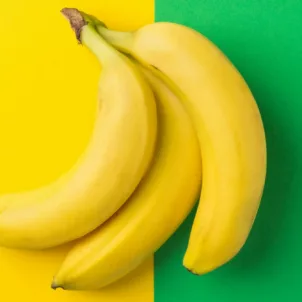Bunch of bananas on half yellow half green background