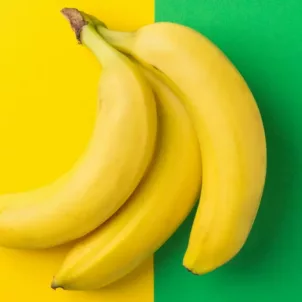 Bunch of bananas on half yellow half green background