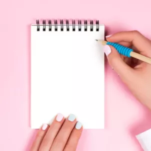 Woman writing to do list to focus