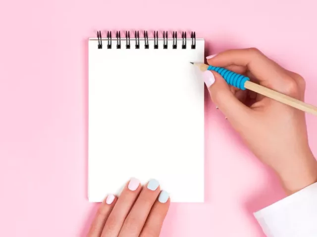 Woman writing to do list to focus