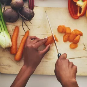 Overhead shot on woman slicing vegetables for batch cooking