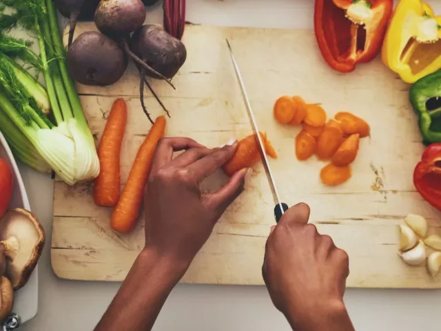 Overhead shot on woman slicing vegetables for batch cooking