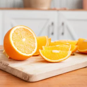 Sliced oranges and orange juice on the counter as an example of immunity boosting foods