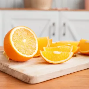 Sliced oranges and orange juice on the counter as an example of immunity boosting foods