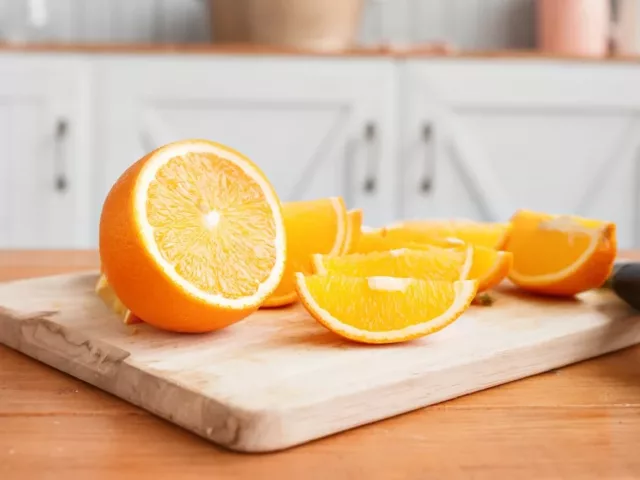 Sliced oranges and orange juice on the counter as an example of immunity boosting foods