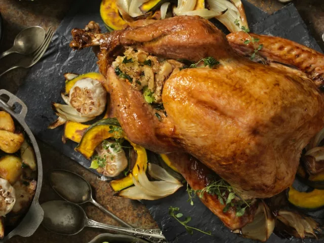 Overhead shot of Thanksgiving dinner with turkey, gravy, and vegetables