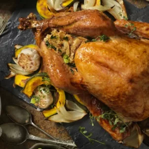 Overhead shot of Thanksgiving dinner with turkey, gravy, and vegetables