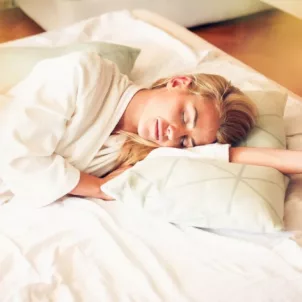 Woman sleeping peacefully on a luxurious Hastens mattress