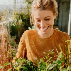 Calm woman gardening rhodiola rosea herb