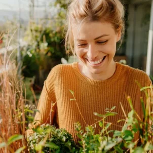 Calm woman gardening rhodiola rosea herb