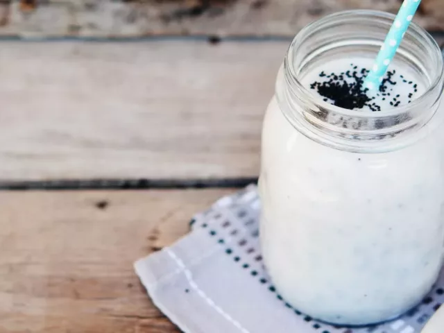 Jar of Skin-Hydrating Coconut Crush Smoothie on wooden table outdoors