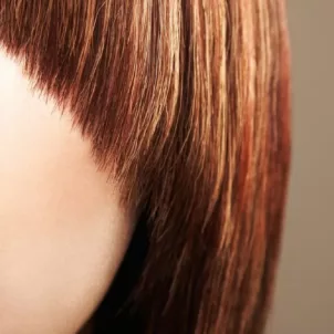 Close up crop of a woman with a bad haircut and bangs.