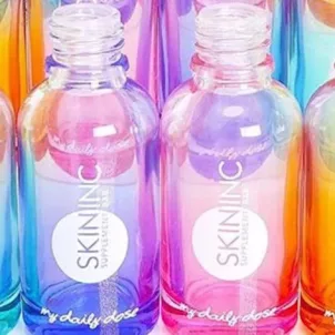 Iridescent, rainbow-colored Skin Inc bottles