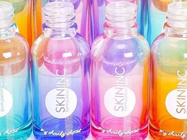 Iridescent, rainbow-colored Skin Inc bottles