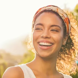 Woman outside smiling in the afternoon sun