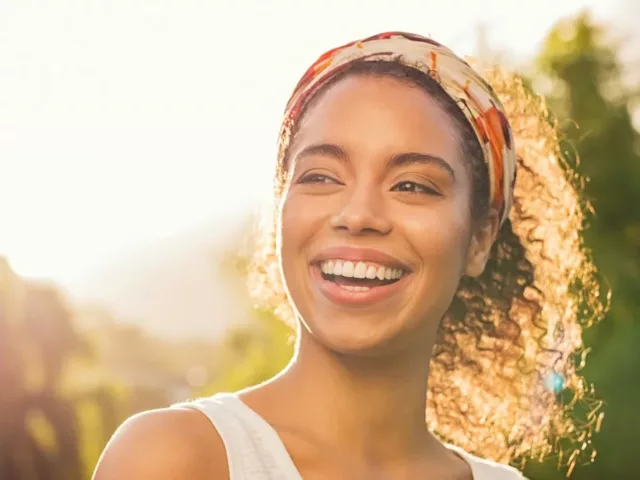 Woman outside smiling in the afternoon sun