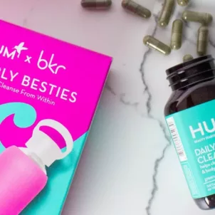 Box including HUM Daily Cleanse and pink bkr water bottle