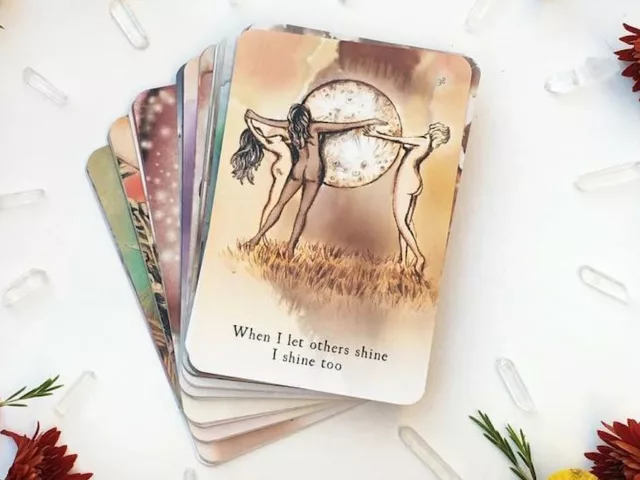 Moon Deck wellness cards in a calming crystal and floral setting