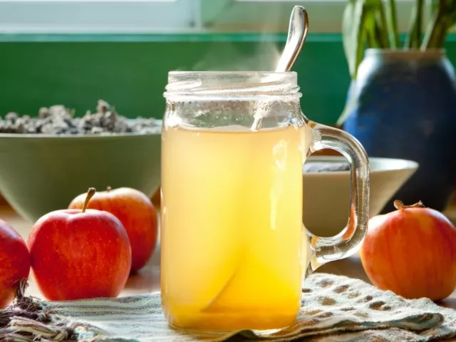 Apple Cider Vinegar in a jar next to red apples