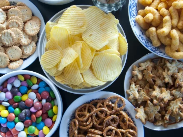 Table full of bowls of junk food, which have unhealthy food additives