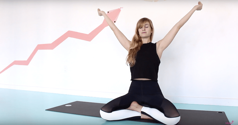 Yoga teacher demonstrating skull-shining breathing exercise or kapalabhati