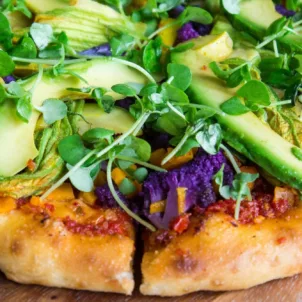 Veggie pizza with sprouts and avocado