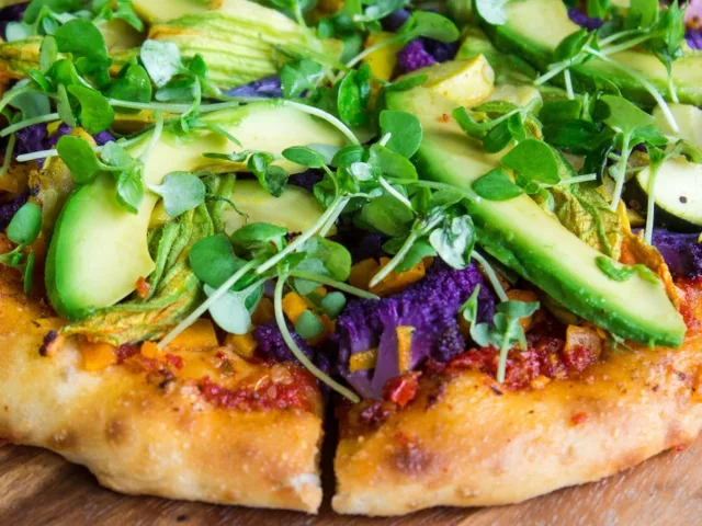 Veggie pizza with sprouts and avocado