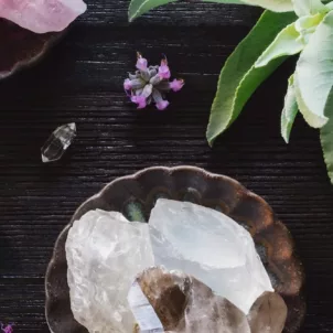 Crystals and plants on a pretty desk setting