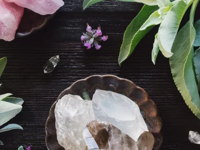 Crystals and plants on a pretty desk setting