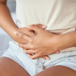 Woman clutching her stomach from dietary pain