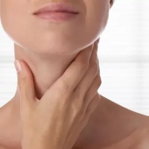 Woman checking on her thyroid glands under neck