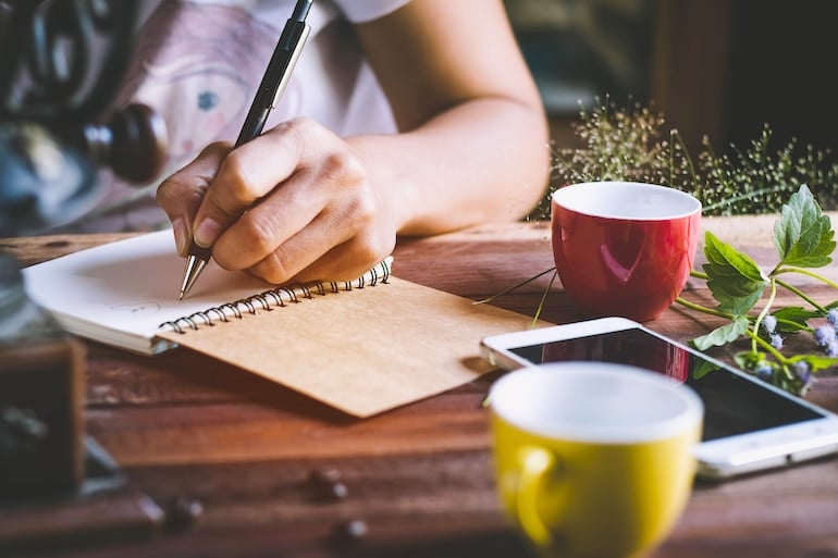 Woman tracking diet in notebook 