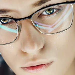 Woman wearing blue light glasses to protect from screen time