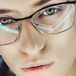 Woman wearing blue light glasses to protect from screen time