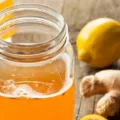 Mason jar of fresh kombucha with ginger and lemon