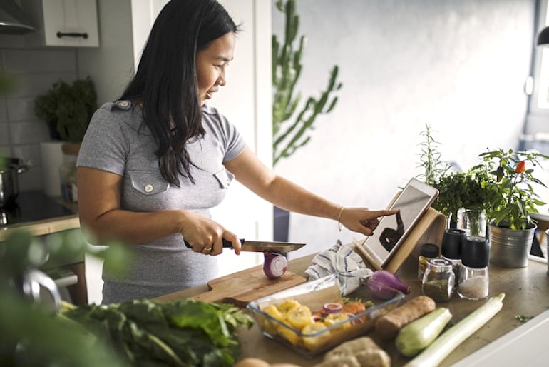 Woman following meal planning tips from a dietitian with her Trader Joe's groceries