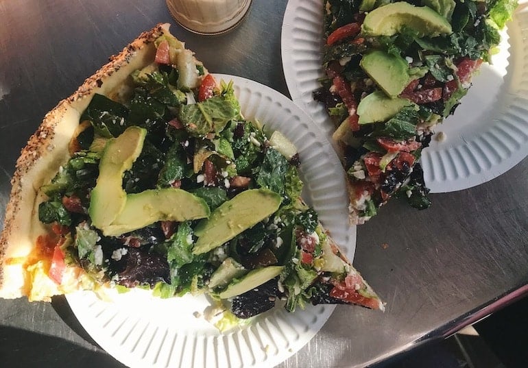 Salad pizza in Venice, CA with avocado, lettuce,a and tomato.