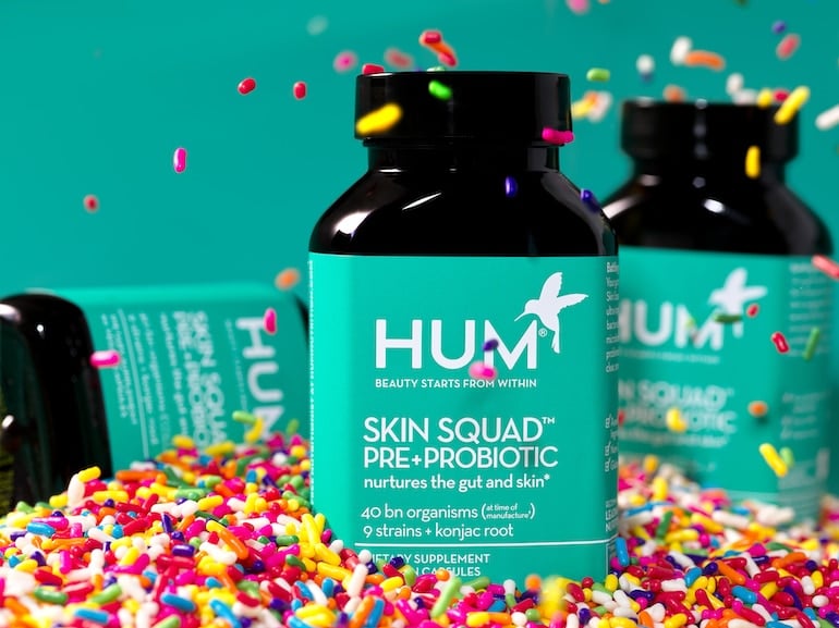 Skin Squad Pre + Probiotic Supplement for Clear Skin in a pool of sprinkles