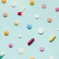Colorful vitamins laid out on bright blue background