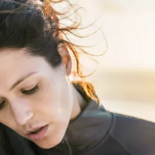 Woman outdoors with fist to face suffering from iron deficiency