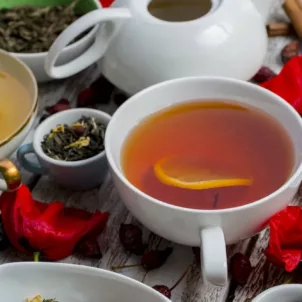 Assortment of teas on a white wooden table covered with flowers